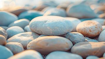 Serene scene with smooth, colorful pebbles on a beach gently lit by sunlight, creating a calming ambiance photo