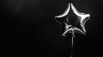 A shiny silver starshaped balloon floats against a deep black background, creating a festive atmosphere that enhances the charm of any special occasion, making it even more memorable photo