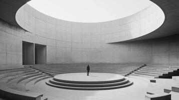 A stunning circular concrete amphitheater flooded with natural light creates a dramatic atmosphere, perfect for various presentations and performances, accommodating a wide range of events photo