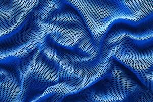 This striking and vivid blue fabric texture is perfect for sports jerseys. It showcases smooth and dynamic waves, making it an excellent choice for all types of activewear designs photo