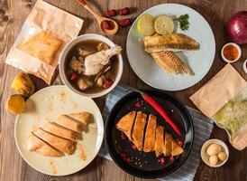 Spicy Grilled Chicken Breast Meal, Thai Lime Shufei Snapper fish, Ginseng Glutinous Rice Chicken Soup, Sweet Potato and Jujube red dates served on table stop view of assorted taiwanese food photo