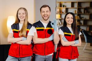 Group of people with cpr dummy looking at camera and smiling after first aid training class photo