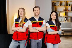 Group of people with cpr dummy looking at camera and smiling after first aid training class photo