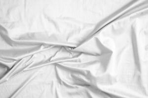 Abstract white wrinkled bedding sheet fabric texture background photo