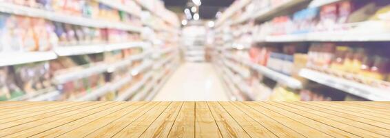 Empty wood table top with supermarket blurred background for product display photo