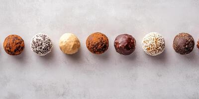 Row of coated truffles at the top, evenly spaced, oriented towards the center photo