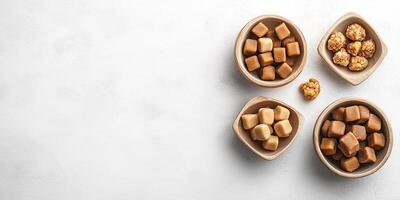 Soft caramel candies placed in decorative bowls of different shapes photo