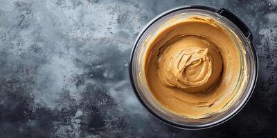Peanut butter in food processor with oil separating on top photo