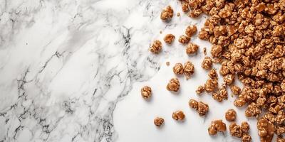 Overhead view of caramel clusters scattered across a marble countertop photo