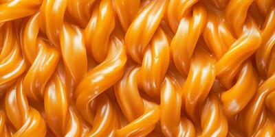 Multiple soft caramel pieces twisted together to form rope-like structures photo