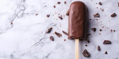 Ice cream bar on stick dipped in chocolate to create outer shell photo