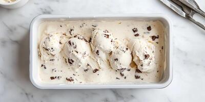 No-churn ice cream in loaf pan with spatula marks visible photo