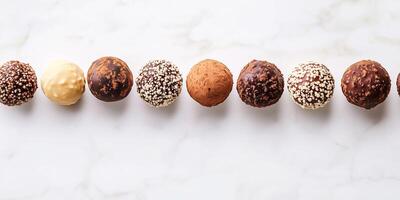 Row of coated truffles at the top, evenly spaced, oriented towards the center photo