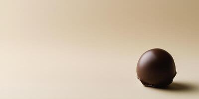 Single bonbon in the bottom right corner, contrasting with empty space above photo