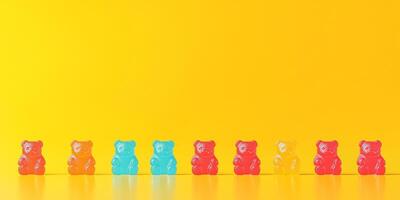 Candy pieces shaped like miniature bears lined up in rows on a surface photo