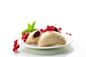 steamed sweet homemade dumplings with berries, red currants.Isolated on white background photo