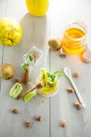 Homemade yogurt in a glass jar with honey, kiwi, nuts.on wooden table photo
