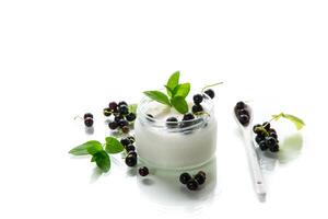 homemade sweet yogurt in a jar with black currants. Isolated on white background photo