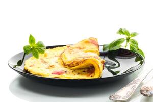 fried omelette with sweet pepper and vegetables in a plate, isolated on white background photo