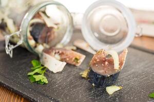 lightly salted mackerel sliced into pieces with onions and spices photo
