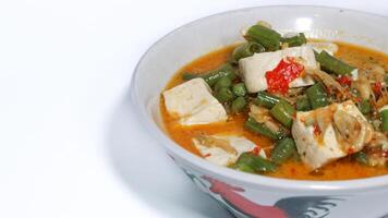 Tumis kacang panjang or stir fried long bean and tofu known as simple asian dish with light and savoury taste. photo