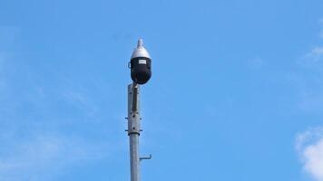 Three CCTV cameras and and an autonomous lighting system based on an LED lamp are installed on pole located on city street photo