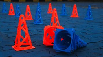 Orange cones and blue cones set up on a blue field for high school sports speed drills. photo