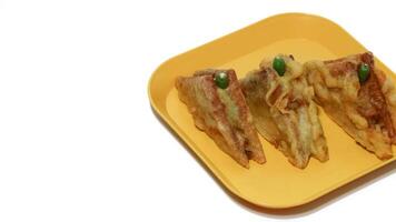 Roti Goreng is common fritter snack in Indonesia which made of white bread filled with creamy chicken and vegetable. photo