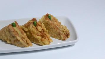 Roti Goreng is common fritter snack in Indonesia which made of white bread filled with creamy chicken and vegetable. photo