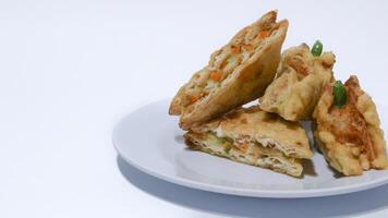 Roti Goreng is common fritter snack in Indonesia which made of white bread filled with creamy chicken and vegetable. photo