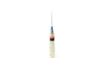 Vial of Drug or Vaccine and 3 ml Plastic Syringe with Needle Isolated on the White Background, blue tone color photo