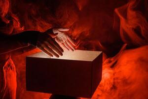 Man opens magic box with surprise on dark background, mystical box, surprise, halloween photo