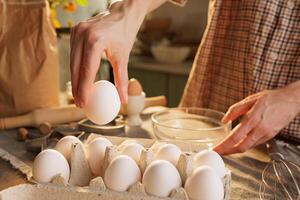 Hand taking out egg from egg carton in kitchen photo