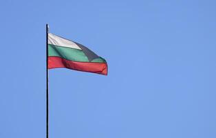 The national flag of Bulgaria in the wind against a blue sky photo
