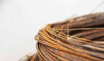Close up of rusty coiled metal wires against a light background photo