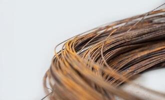 Rusty coil of wires captured up close on a light background photo