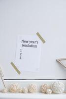 Motivational paper note NEW YEAR'S RESOLUTION. Goals setting concept. Strategy for self development improvement. Inspirational Planning better healthier life. Visual motivation photo
