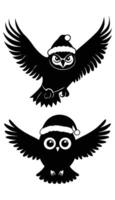 Two black owls with santa hats vector