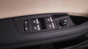 Close-up of buttons on car door. Action. Car door glass control panel. Stylish design of keypad on car door video