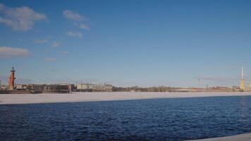 Beautiful river on background of ancient architecture of city. Action. Blue river with ice on background of shore of ancient city. River with ice on background of shore and ancient buildings on sunny video