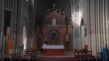 A large temple with a bright light. Action. A large church with bright lights, candles and painted hanging icons and chairs for visitors. video