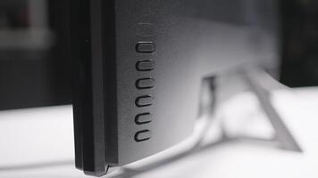 Close-up of buttons behind monitor. Action. Buttons behind computer monitor. TV or computer monitor display buttons video