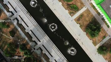 View of small fountains taken from a helicopter. Stock footage. Summer time with fountains and small houses and green parks around. video