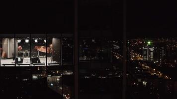 Boxers in skyscraper. Stock footage. Top view of people in apartments of skyscraper at night. Boxers are engaged on high floor of high-rise video