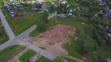 Bird's-eye view of a small town. Clip. A green area with small houses and overgrown green trees around. video