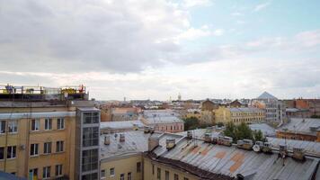Aerial view of a summer southern city on a cloudy sky background. Action. Many roofs of buildings. video