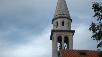 A large tower next to the houses. Creative. Beautiful architecture near the sea and mountains with an old concept. video
