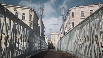 Beautiful view of ancient pedestrian bridge and ancient architecture of buildings. Action. Street view from beautiful pedestrian bridge. Pedestrian bridge on background of ancient city and people video