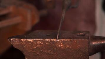 Hard work with iron. Media. A blacksmith who works with split fire to deform iron. video