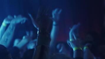 An event at the club. Clip. A party in a cramped room with lights dancing with people and dancers on the dance floor. video